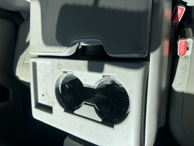 Before interior detailing: sticky front center console cup holder in a Ford F-150 Lariat