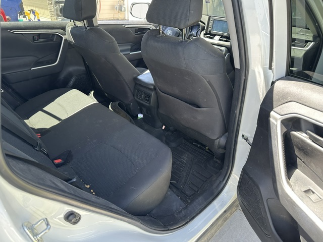 Before interior detailing: dust-covered rear seats and console in a Toyota RAV4