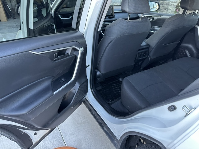 After interior detailing: clean passenger seat, door panel and floor in a white Toyota RAV4
