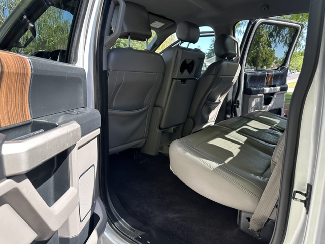 After interior detailing: clean passenger side door panel, leather seat, and floor in a Ford F-150 Lariat