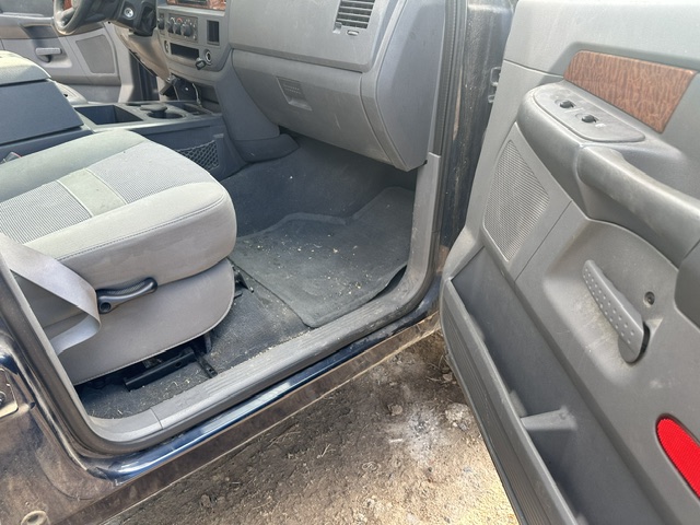 Before interior detailing: grimy rear door panel and dirty floor in a Dodge Durango