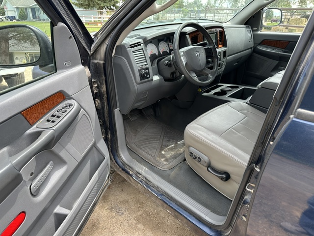 Before interior detailing: dirty passenger seat, dash and floor mat in a Dodge Durango